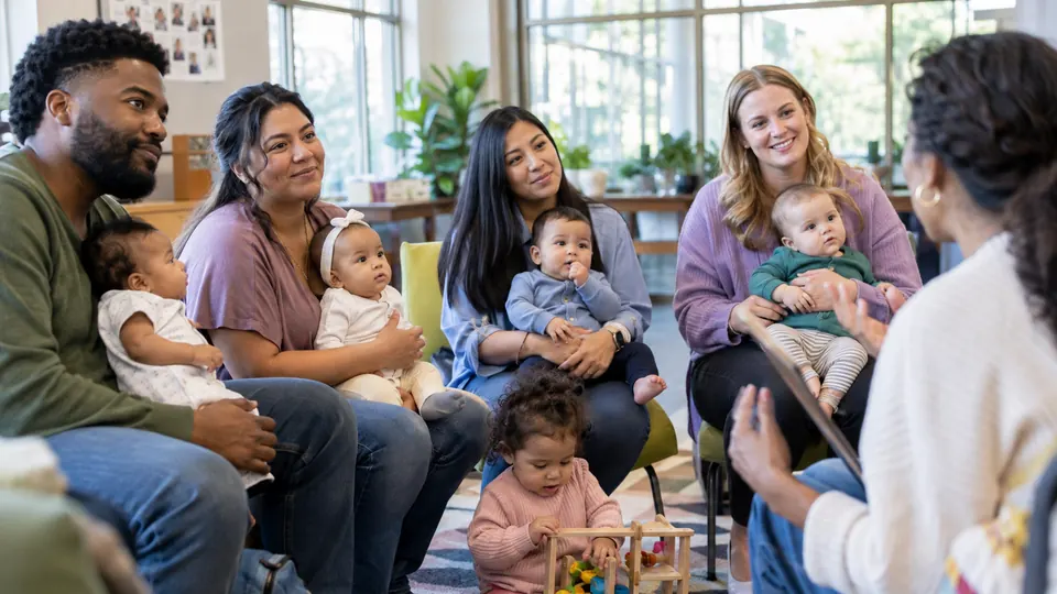 Parents with young children talking together.